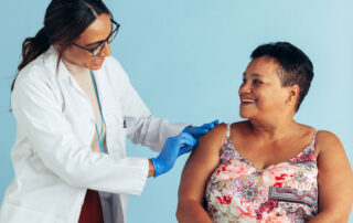 Nurse or pharmacist preparing a woman's arm for the flu shot